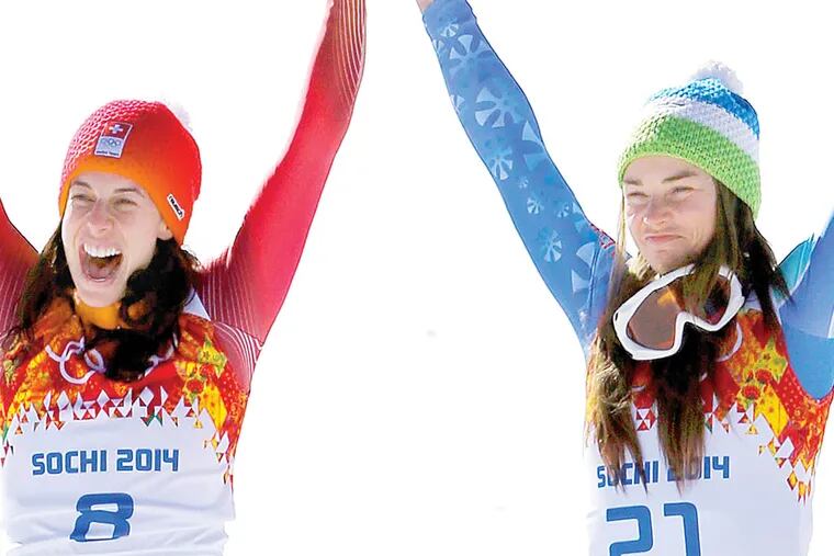 Women's downhill gold medalists Switzerland's Dominique Gisin, left, and Slovenia's Tina Maze, right, celebrate their joint victory.