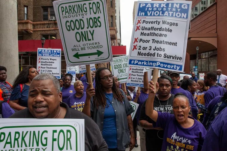 Parking lot attendants and 32BJ SEIU members marched down 16th Street in Center City in September to raise awareness for the parking lot workers' bid to unionize. 32BJ's latest strategy is to work with City Council to regulate the parking industry.