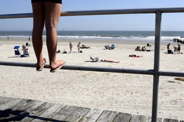 Madison Hollingsworth stands on the boardwalk railing in Ocean City.