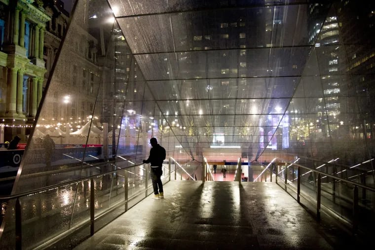 Rain falls on the glass entrance to SEPTA’s underground concourse at Dilworth Park by City Hall. TOM GRALISH / Staff Photographer
