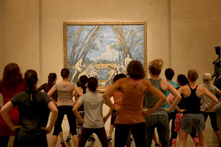 Performers and participants exercise in front of "The Large Bathers" by Paul Cézanne during the Fringe Fest "Museum Workout" at the Philadelphia Museum of Art.