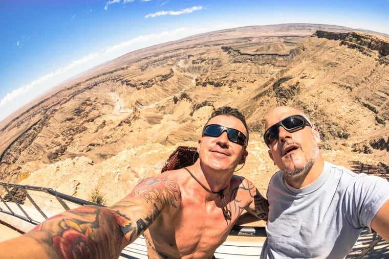 Adventurous best friends taking selfie at Fish River Canyon in Namibia.
