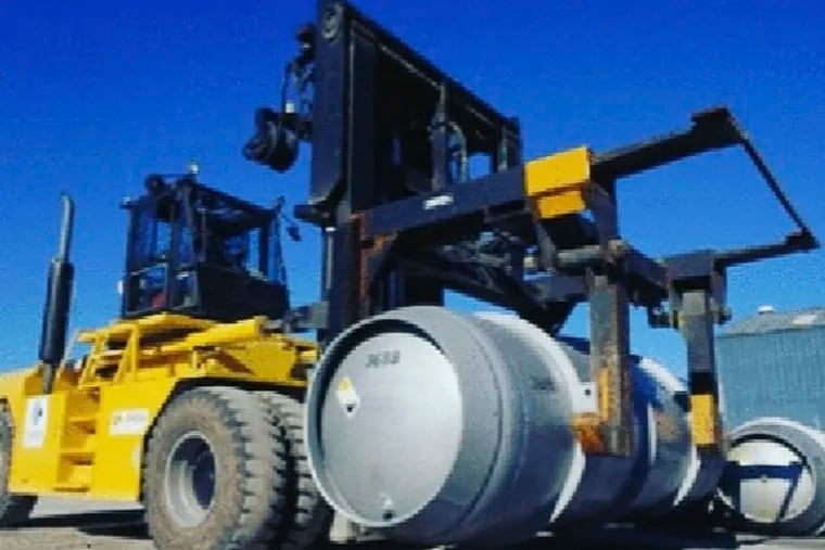 In this November 2019 file photo released by the Atomic Energy Organization of Iran, a forklift carries a cylinder containing uranium hexafluoride gas for the purpose of injecting the gas into centrifuges in Iran's Fordo nuclear facility.