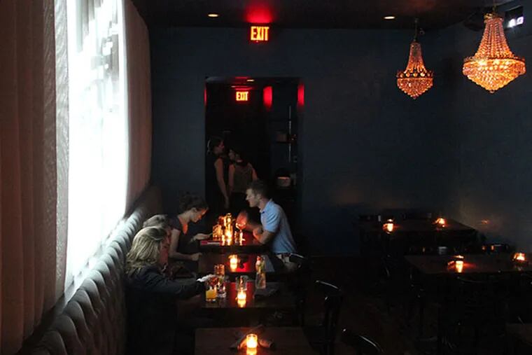 The dining room of Charlie was a sinner. has a white curtain acting as a projection screen.  (MICHAEL KLEIN / Philly.com)