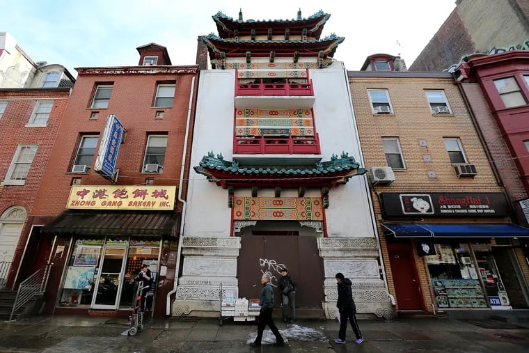Pedestrians walk by the former Chinese Cultural and Community Center on N. 10th Street in Philadelphia.