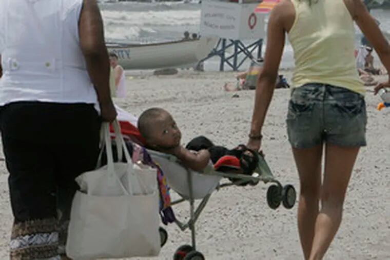 Maquez Corbin gets a ride to the Atlantic City beach from his grandmother Joyce Rivera and his mother, Tiffany Corbin (right). They were visiting from North Bergen, N.J.