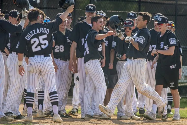 Bishop Eustace’s Ryan Colbert (right) crosses home plate after his first-inning grand slam vs. Ocean City in the first round of the Diamond Classic.