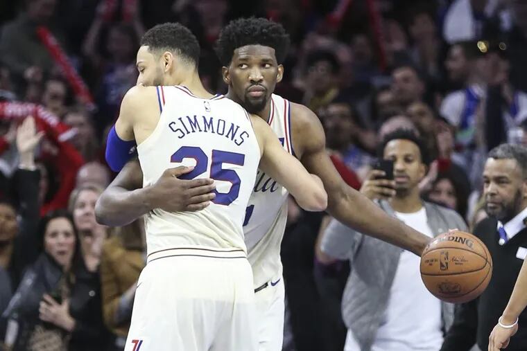 Sixers’ Joel Embiid gets a hug from teammate Ben Simmons after beating the Nets 120-116 at the Wells Fargo Center on Wednesday.