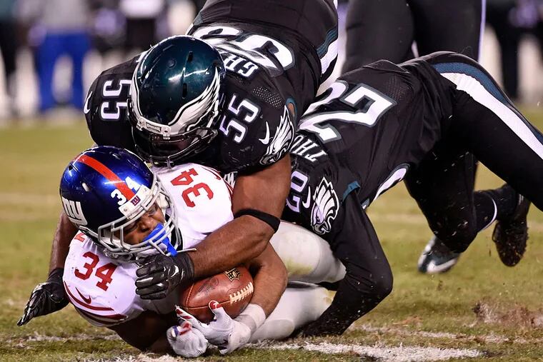 Philadelphia Eagles strong safety Walter Thurmond (26) and outside linebacker Brandon Graham (55) tackle New York Giants running back Shane Vereen (34) at Lincoln Financial Field. The Eagles defeated the Giants, 27-7.