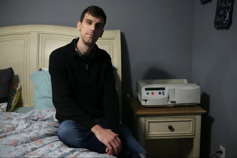 Matt Douglas sits next to the peritoneal dialysis machine at his home in Northfield, N.J. Douglas has focal segmental glomerulosclerosis, a form of kidney disease, and needs a kidney transplant.