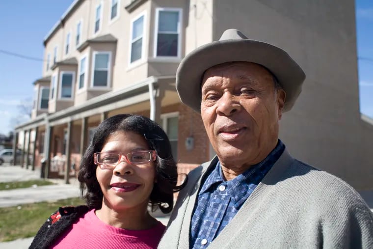 Warren Harrison and his companion Khadijah Abdullah stand in front of rowhouses on Venango Street in 2010. Relatives identified them, and Abdullah's brother, as weekend homicide victims.