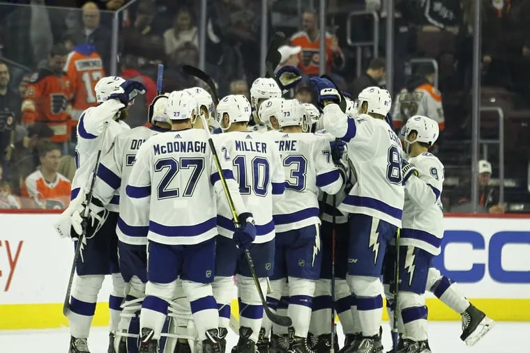 The Tampa Bay Lightning celebrate their 6-5 overtime win over the Flyers Saturday at the Wells Fargo Center.
