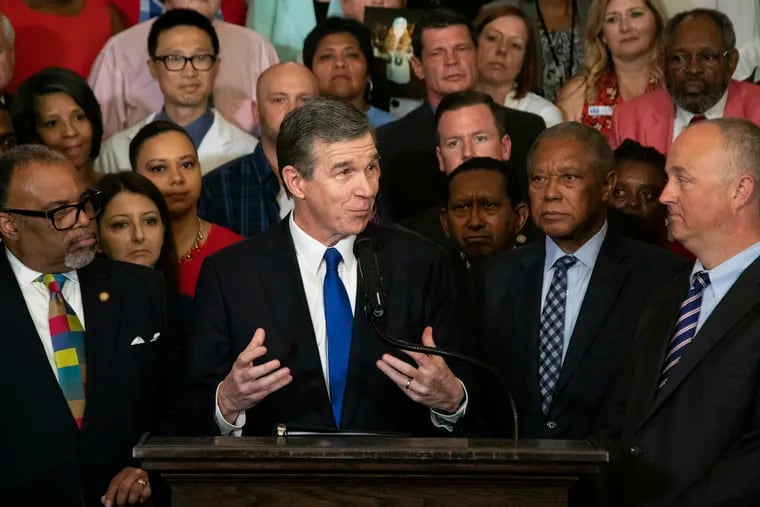 North Carolina Gov. Roy Cooper announces  that he plans to veto a GOP-backed state budget during a press conference in Raleigh, N.C. North Carolina on June 28, 2019. Gov. Cooper signed an order Friday, Aug. 2, 2019 barring the state health department from allowing public funds to pay for conversion therapy for minors. Medical experts say the practice is dangerous for people of all ages.
