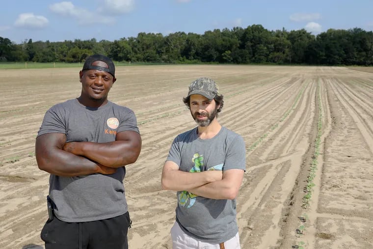 K & J Organic Farms co-owner Kenny Bartee (left) with William Levin in Pittsgrove Township, N.J  William and Malya Levin, a Jewish couple, own the land where K & J, owned by a trio of Black farmers, grows produce. In a sense their two families are carrying on the legacy of South Jersey's Jewish agricultural settlements in the late 19th and early 20th centuries, when local Gentile farmers helped their new neighbors, who had fled persecution, learn how to farm -- and were helped in return.