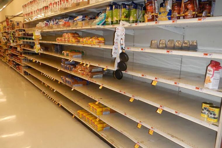 An Acme store near Kings Highway in Haddonfield has nearly bare bread shelves. Grocery stores tried to stock up on many such goods but not on perishables.