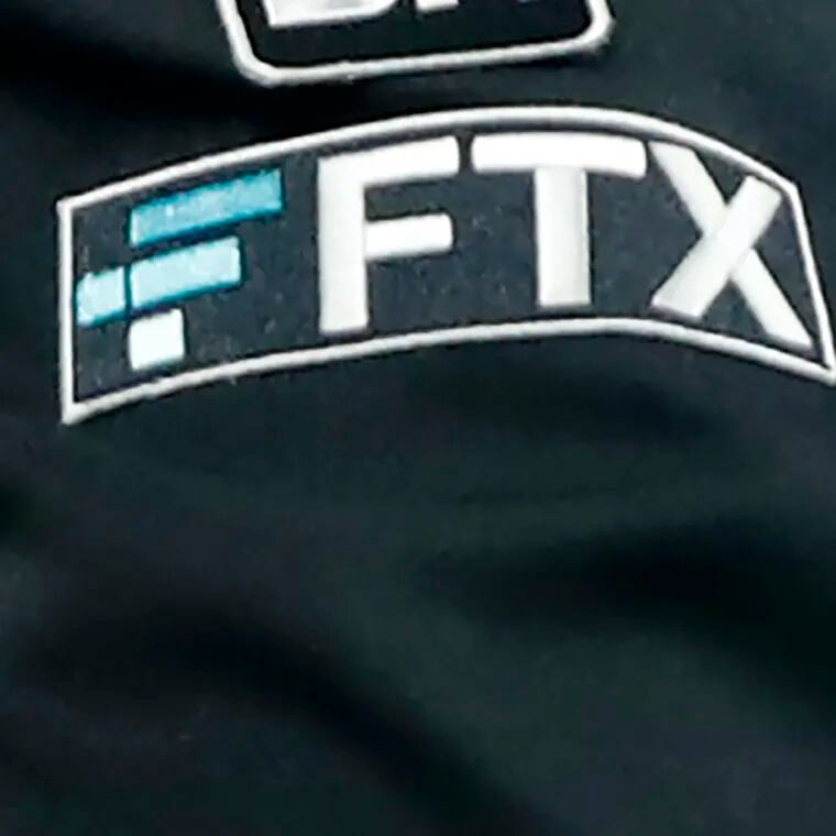 The FTX logo appears on home plate umpire Jansen Visconti's jacket at a baseball game with the Minnesota Twins in 2022 in Minneapolis.