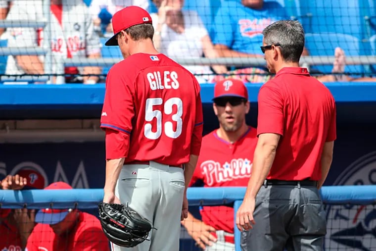 Phillies pitcher Ken Giles leaves the game with a trainer. (Steven M. Falk/Staff Photographer)