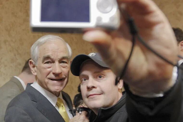 Favored Iowa GOP candidate Ron Paul , posing for a supporter's photo, would be a tough sell later. (Chris Carlson / Associated Press)