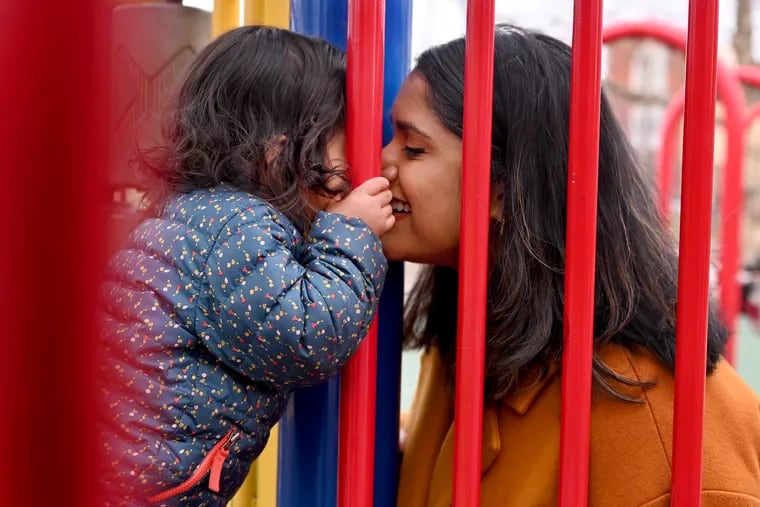 Vidya Viswanathan kisses her 21 month-old daughter Lekha Jain in their neighborhood playground in March.