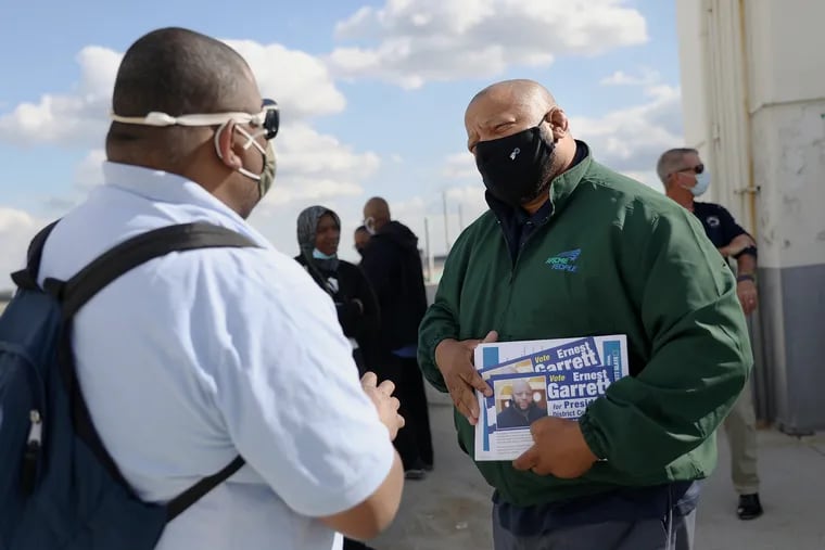 Local 394 business agent Ernest Garrett (right), who is running for president of AFSCME District Council 33, talks to Local 1510 member Janaire Marshall, an airport custodial crew chief, at the Philadelphia Airport.