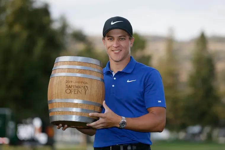 Cameron Champ poses with his trophy on the 18th green of the Silverado Resort North Course after winning the Safeway Open PGA golf tournament in September.