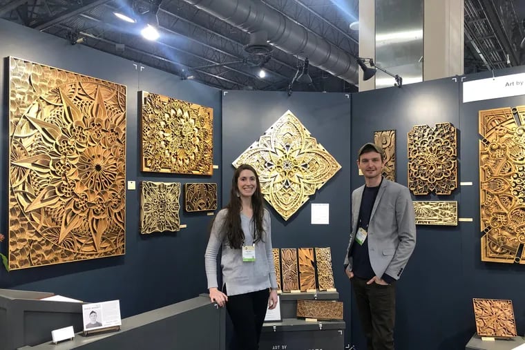 Phillip Roberts and his wife Melinda Roberts standing at their booth at this American Handcrafted Philadelphia show at Pennsylvania Convention Center.
