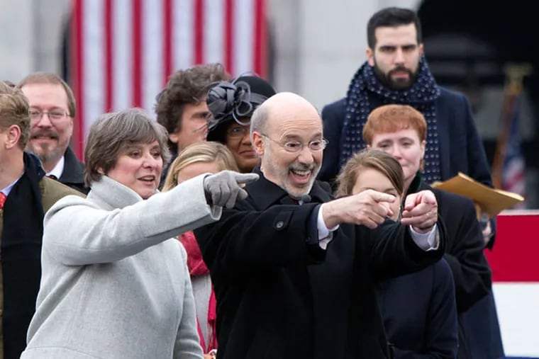 Tom Wolf and his wife, Frances, react to seeing someone in the crowd shortly after taking the stage. Wolf was later sworn in as Pennsylvania's 47th governor in a noontime ceremony on Jan 20, 2015. ( CHARLES FOX / Staff Photographer )