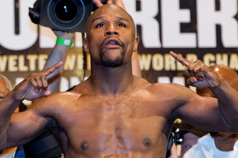 Floyd Mayweather Jr. steps up on the scale during the weigh-in for his WBC world welterweight championship fight against Robert Guerrero, Friday, May 3, 2013, in Las Vegas. Guerrero will challenge Mayweather for the title on Saturday. (Julie Jacobson/AP)