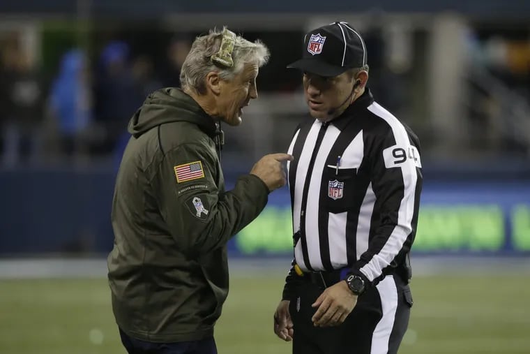 Hugo Cruz (right) lost his job as an NFL official after a missed call two weeks ago.