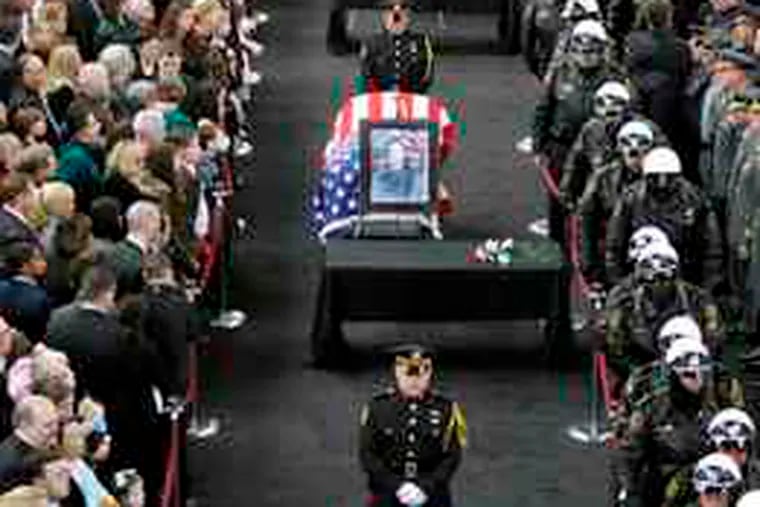 Relatives and law enforcement officials pay their respectsto (from front) Officers Stephen Mayhle, Paul Sciullo II,and Eric Kelly at the City-County Building in Pittsburgh.