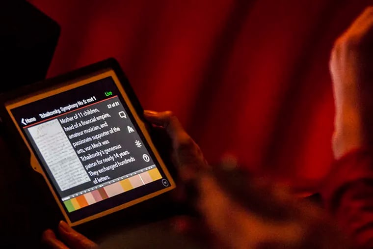 A concertgoer uses the orchestra's LiveNote app during the concert.