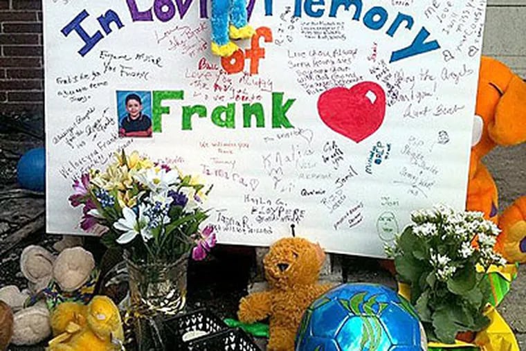 A memorial grows for the 12-year-old autistic boy killed in a house fire on Saturday in West Philadelphia. (Staff photo by Michael Broecker)