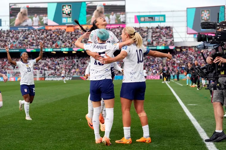 Sophia Smith (center) celebrates with Megan Rapinoe and Lindsey Horan after assisting Horan's goal that finished off the United States' win.