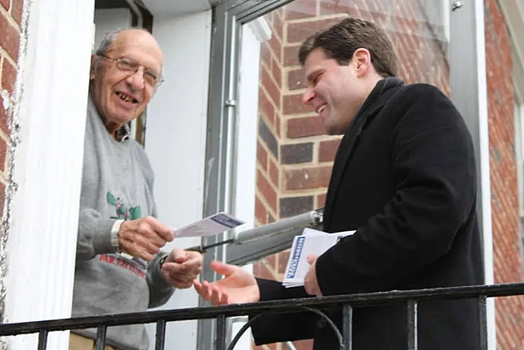 Jared Solomon, right, president of Take Back Your Neighborhood, is seeking to unseat state Rep. Mark Cohen. He kicked off his political debut on New Year's Eve in the Lower Northeast, going door to door when he greeted Morton Flashner, 94, of Castor Gardens. PHOTO: GEORGE MATYSIK