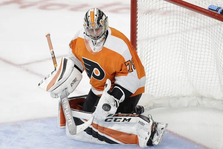 Flyers goalie Carter Hart stops the puck against the New York Islander during the second period in a preseason game on Friday.