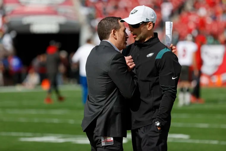 Eagles GM Howie Roseman (left) with embattled defensive coordinator Jonathan Gannon on Sunday at Raymond James Stadium in Tampa, Fla.
