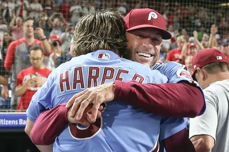 Phillies' manager Gabe Kapler hugs Bryce Harper after Harper's walkoff grand slam beat the Cubs, 7-5, at Citizens Bank Park on Thursday night.