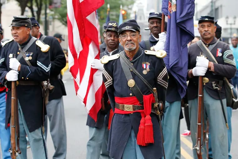 Sgt. Major Joseph H. Lee stands with members of the 3rd Regiment United States Colored Troops reenactors during the Juneteenth Parade, recognizing the end of slavery in America, along East Market Street on Saturday, June 23, 2018. YONG KIM / Staff Photographer