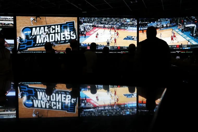 People watch coverage of the NCAA basketball tournament at the Westgate Superbook sports betting casino in Las Vegas.