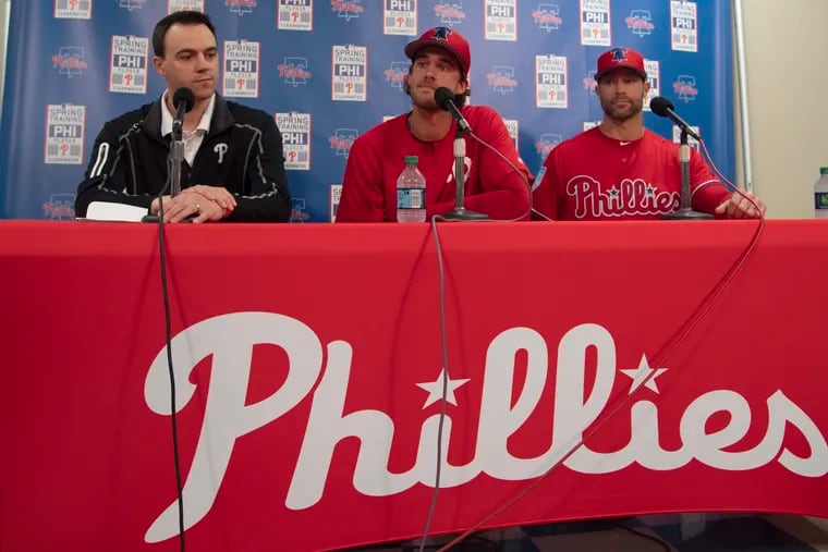 Matt Klentak (left) and Gabe Kapler need someone who can follow Aaron Nola (center) in the rotation.