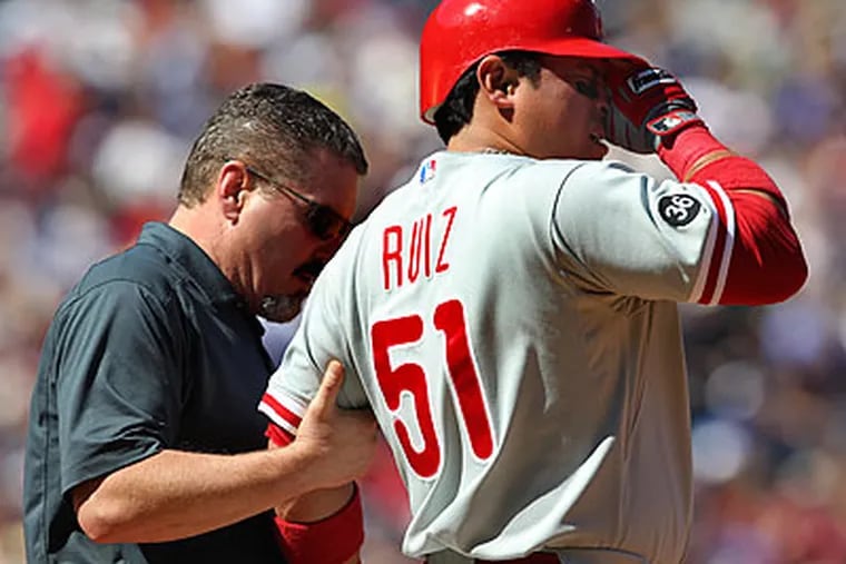 Carlos Ruiz was drilled in the arm by a pitch from Tim Hudson during the Philies' 8-7 loss in Atlanta on Sunday. (John Bazemore/AP)