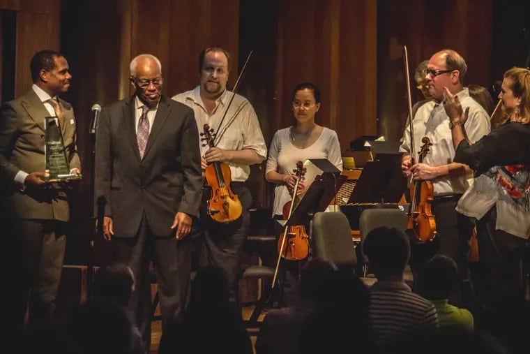 Astronaut Bluford Guion Jr. (second from left) applaused at the Mann Center, before Philadelphia Orchestra musicians, at the debut of “Hold Fast to Dreams” by Nolan Williams Jr. (left).