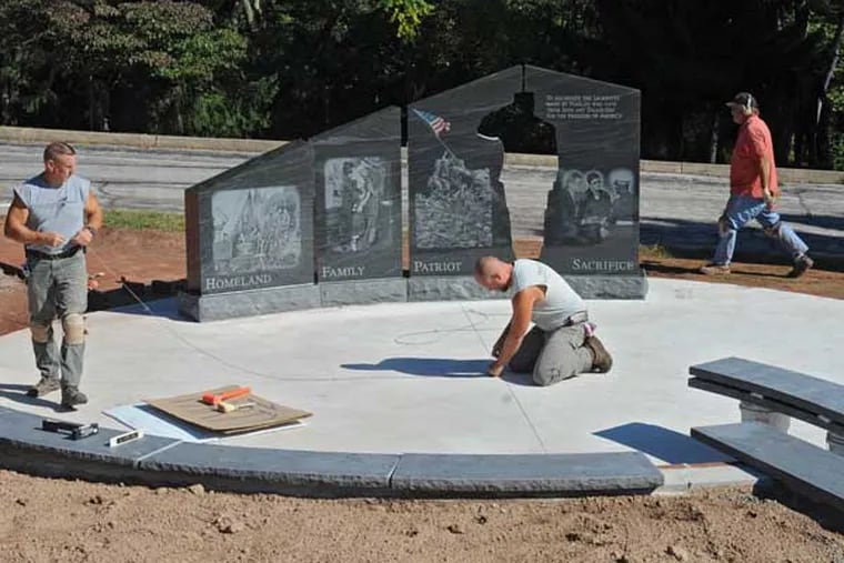 Workers put the finishing touches on the Gold Star Families Memorial on the campus of the Freedoms Foundation at Valley Forge on Sept. 17, 2014. The memorial honors families who have lost a loved one while serving in the military in defense of freedom. ( CLEM MURRAY / Staff Photographer )
