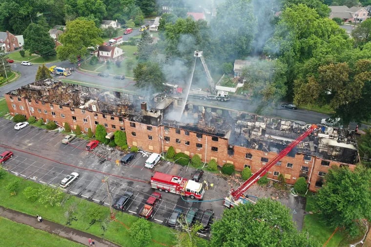 Fire fighters work on hot spots after a devastating fire at the Ashwood Apartments on Worth Blvd., in North Coventry Township, Friday, July 31, 2020. The blaze struck about 7 p.m. on Thursday evening displacing about 100 residents of the complex.