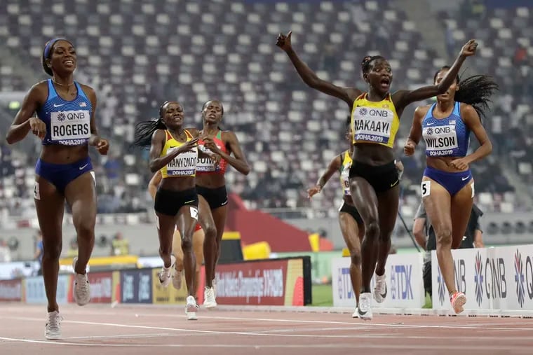 Halimah Nakaayi of Uganda celebrates as she wins the gold medal in the women's 800-meter final ahead of Raevyn Rogers (left) and Ajee' Wilson (right), both of the United States, at the World Athletics Championships in Doha, Qatar on Sept. 30, 2019.