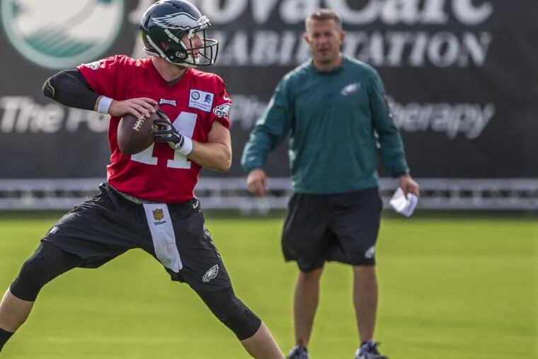 John DeFilippo, right, watching Carson Wentz during Eagles training camp in 2017.