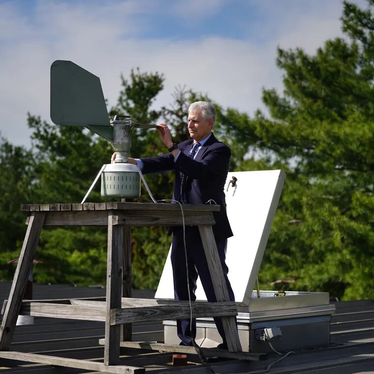 Donald Dvorin collects a pollen sample from a trap on the roof of his practice in the spring of 2021.