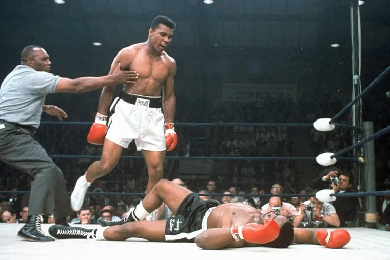 In this May 25, 1965, file photo, heavyweight champion Muhammad Ali is held back by referee Joe Walcott, left, after Ali knocked out challenger Sonny Liston in the first round of their title fight in Lewiston, Maine.