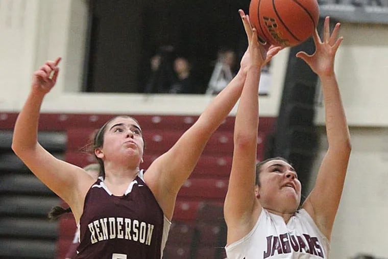 A pass to Sabrina Fusco, right, of Garnet Valley  alludes the
outstretched arms of  Brynn Cullinan, left, of West Chester Henderson
in the first half on Dec. 27, 2013.  (Charles Fox/Staff
Photographer)