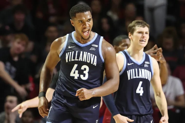 Eric Dixon (left) and Chris Arcidiacono of Villanova celebrate after a Dixon basket during the second half against Temple last week.